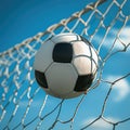 Football ball flew into the goal. Soccer ball flying into net against blue sky background. Outdoor game Royalty Free Stock Photo