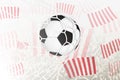 Football ball in goal net on crowd background with red and white vertical stripes club flag Royalty Free Stock Photo