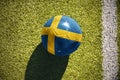 Football ball with the national flag of sweden lies on the field Royalty Free Stock Photo