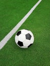 Football ball over green soccer field Royalty Free Stock Photo