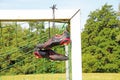 Football boots hanging on a football post