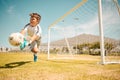 Football, boy goalkeeper and jump, saving ball from goals at outdoor sports field. Soccer, kid and competition game with Royalty Free Stock Photo