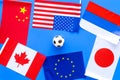 Football championat. American, Canadian, European, Japanese, China, Russian flags and football ball on blue background