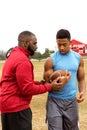 Football coach coaching an athlete Royalty Free Stock Photo