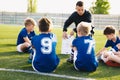 Football coach coaching kids. Soccer football training session for young boys