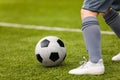 Football detail. Kicking the soccer ball. Football player feet on the grass pitch