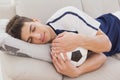 Football fan sleeping with ball Royalty Free Stock Photo