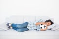 Football fan sleeping on couch hugging ball Royalty Free Stock Photo