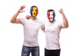 Football fans of France and Romania national teams friendly suport together the game of their teams at match Royalty Free Stock Photo