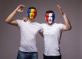 Football fans of France and Romania national teams friendly suport together the game of their teams at open match Royalty Free Stock Photo