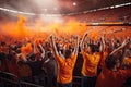 Football fans in orange tshirts at the stands of the stadium, Fans celebrating and cheering inside a stadium, AI Generated