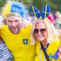 Football fans from Sweden, married couple, with painted faces in national colors before the match England Sweden at the World Cup