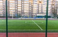 Football field with artificial lawn. Stadium and sports grounds near