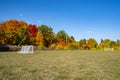 Football Field With Colorful Trees in the Background on a Sunny Autumn Day Royalty Free Stock Photo