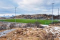 Football field on Lofoten Islands surrounded by rocks, stones and water, Henningsvaer, Norway