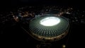 Football field at modern sports arena, fantastic aerial view, night megalopolis