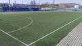 A football field of reduced size with artificial turf for training and games of young football players. There are gates and markin