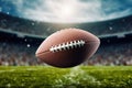 Football in Flight Over Field: Striking image capturing an American football in mid-flight, dominating the football Royalty Free Stock Photo