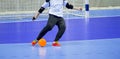 Football Futsal Ball and man Team. Indoor Soccer Sports Hall. goalkeeper with a ball Royalty Free Stock Photo