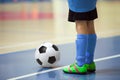 Football futsal training for children. Indoor soccer young player