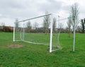 Football goal post on a training ground. Worn out grass on a keeper spot. Soccer theme background