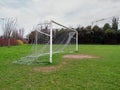 Football goal post on a training ground. Worn out grass on a keeper spot. Soccer theme background
