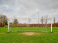 Football goal post on a training ground. Worn out grass on a keeper spot. Soccer theme background