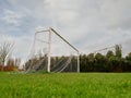 Football goal post on a training ground. Worn out grass on a keeper spot. Soccer theme background