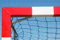 Football or handball goal with red and white goalpost. Sport, recreation and healthy lifestyles on fresh air