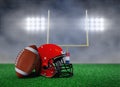 Football and Helmet on Field with Goal Post Royalty Free Stock Photo