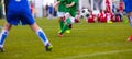 Football kick. Soccer ball in motion. Young soccer player Royalty Free Stock Photo