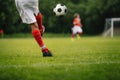 Football Kick. Youth Player Kicking Soccer Ball on Field Royalty Free Stock Photo