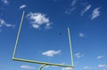 Football kicked through the Goal Posts