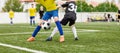 Football Kids Playing Game. Two Players in Opposing Teams in a Duel