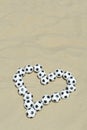 Football Love Heart Made with Soccer Balls on Beach Royalty Free Stock Photo