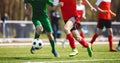 Football men running the ball in a duel. Adult soccer players in the competition game