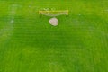 Football net on the background of a green football field. Aerial view of football gate