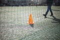 Football net on the field. Orange triangle.
