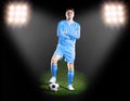 Football player in blue uniform. on grass field in the spotlight Royalty Free Stock Photo