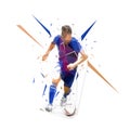 Football player in dark blue jersey running with ball, abstract low poly vector drawing. Soccer player kicking ball. Isolated Royalty Free Stock Photo