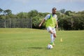 Football player dribbling the soccer on the football ground Royalty Free Stock Photo