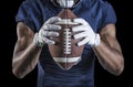 Football Player holding a football tightly at his chest Royalty Free Stock Photo