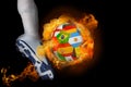 Football player kicking flaming international flag ball