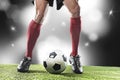 Football player in red socks and black shoes running and dribbling with the ball playing on stadium Royalty Free Stock Photo