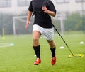 Football player runs while dragging weights behind him. Running with weights soccer training. Royalty Free Stock Photo