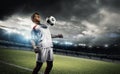 Football player withstand a ball with his chest in the stadium