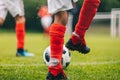 Football Players Kicking Ball on Grass Venue. Football Pitch Stadium in the Background Royalty Free Stock Photo