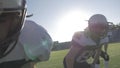 Football players in slow motion at sunset