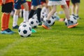 Football practice for youth. Children soccer training background. Group of young boys training soccer drills on green grass