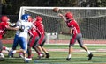 Football quarterback passing the ball over his lineman Royalty Free Stock Photo